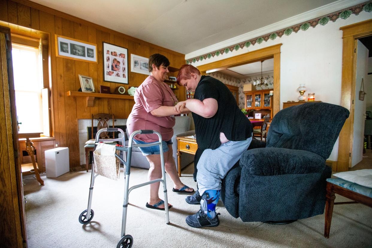 Tina Blumka helps her daughter, Hannah Blumka, out of a chair Wednesday, June 1, 2022 at their home in Buchanan.