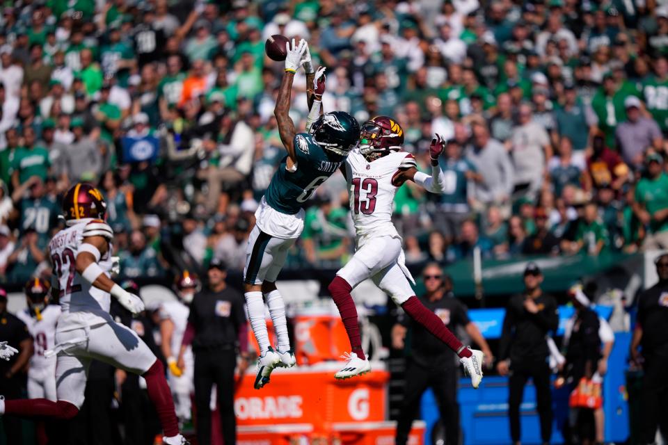 Philadelphia Eagles wide receiver DeVonta Smith (6) catches a pass in front of Washington Commanders cornerback Emmanuel Forbes (13) during the first half of an NFL football game Sunday, Oct. 1, 2023, in Philadelphia.