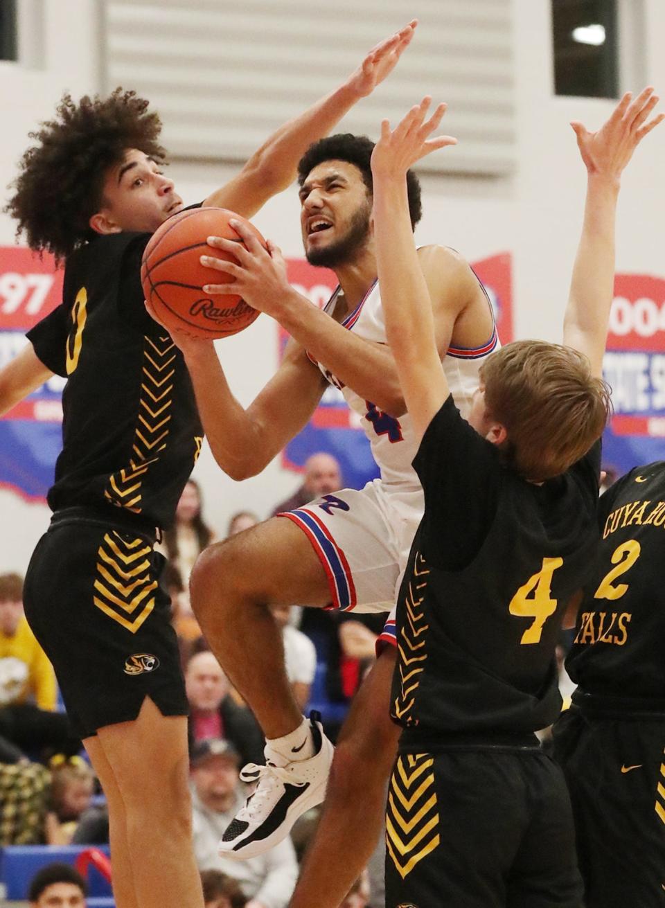 Revere's Carson Banks goes to the basket between  Cuyahoga Falls' Justin Wilkes and Joey Earl on Friday, Jan. 20, 2023.