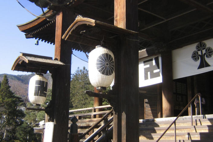 This photo provided by the Rev. TK Nakagaki in November 2022 shows the Zenko-jo Buddhist temple in Nagano, Japan, founded in 642 AD, Japan's first Buddhist temple. The swastika symbol is found in the temple's banners, paper lanterns, pillars, roof tiles and in the main shrine alongside the temple crest design of the hollyhock flower. (The Rev. TK Nakagaki via AP)