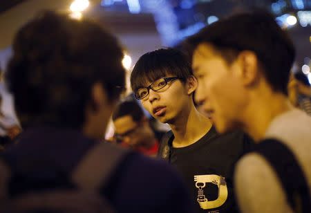 Joshua Wong, leader of the student movement, talks to reporters outside the government headquarters office in Hong Kong October 9, 2014. REUTERS/Carlos Barria