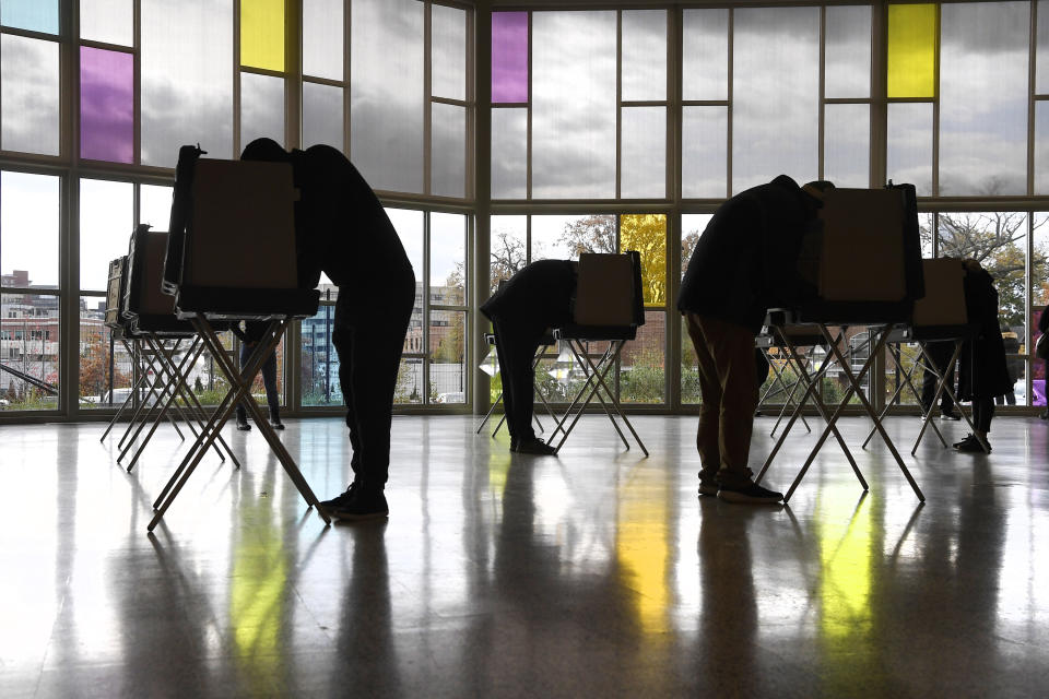 Voters mark their ballots at First Presbyterian Church on Election Day, Tuesday, Nov. 3, 2020, in Stamford, Conn. (AP Photo/Jessica Hill)