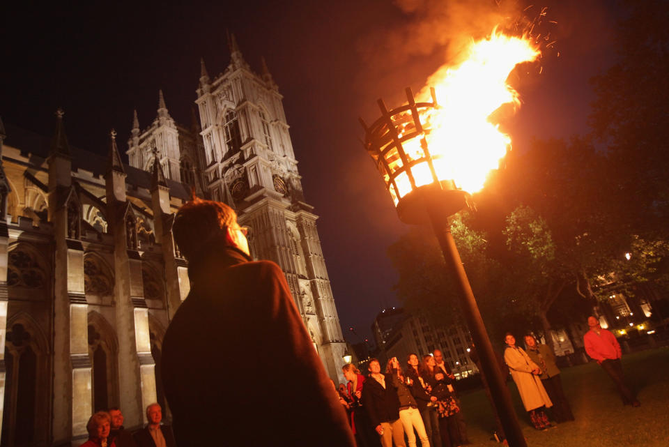 LONDON, ENGLAND - JUNE 04:  Clergy and volunteers of Westminster Abbey and their guests watch a beacon they had lit moments before burn outside the Abbey as part of Diamond Jubilee celebrations on June 4, 2012 in London, England. All across the globe 4,150 beacons were lit in Commonwealth countries in honour of Queen Elizabeth II. For only the second time in its history, the UK celebrates the Diamond Jubilee of a monarch. Her Majesty Queen Elizabeth II celebrates the 60th anniversary of her ascension to the throne.  (Photo by Sean Gallup/Getty Images)
