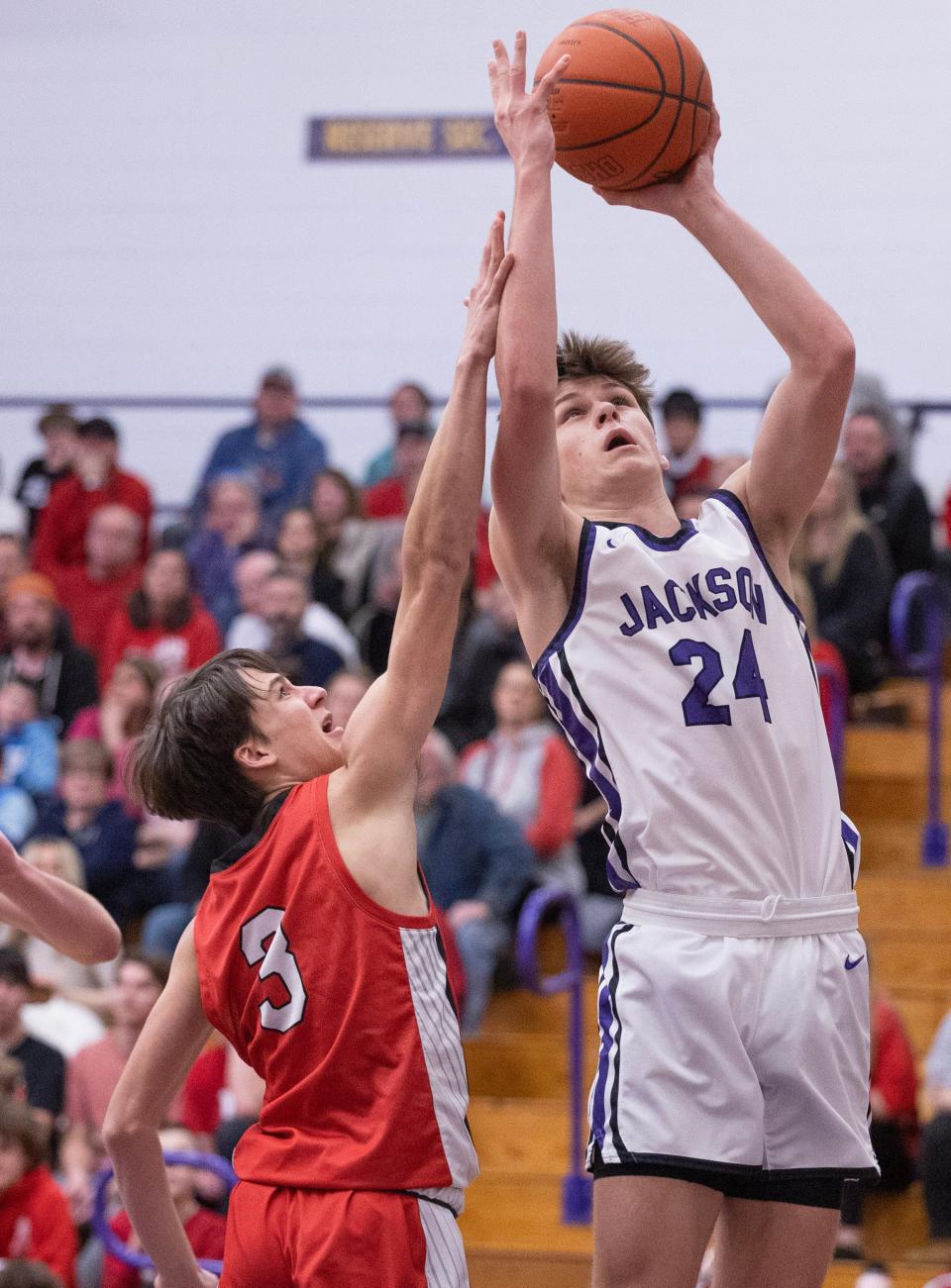 Jackson's Kyle Monterrubio shoots as Wadsworth's Caden Shriver defends during a boys varsity basketball at Jackson on Tuesday, Feb.13, 2024.