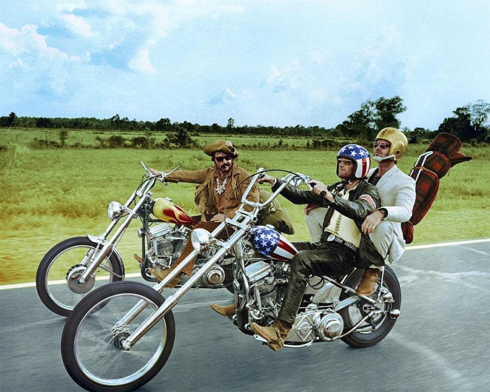 Dennis Hopper and Peter Fonda, wearing a stars-and-stripes helmet, riding their chopper motorcycles, with Jack Nicholson in the 1969 classic Easy Rider (Getty Images)