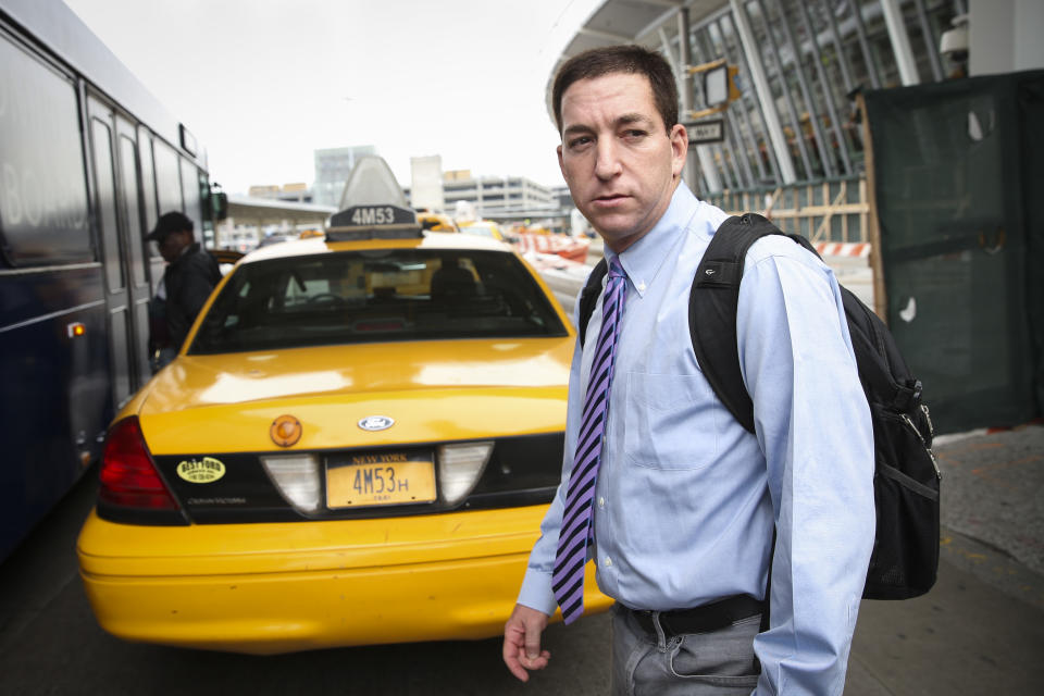 Glenn Greenwald arrives at John F. Kennedy International Airport on Friday, April 11, 2014 in New York. Greenwald and Laura Poitras of the Guardian share a George Polk Award for national security reporting with The Guardian's Ewen MacAskill and Barton Gellman, who has led The Washington Post's reporting on the NSA documents. Greenwald returned to the United States for the first time since the story broke to receive the journalism award. (AP Photo/John Minchillo)