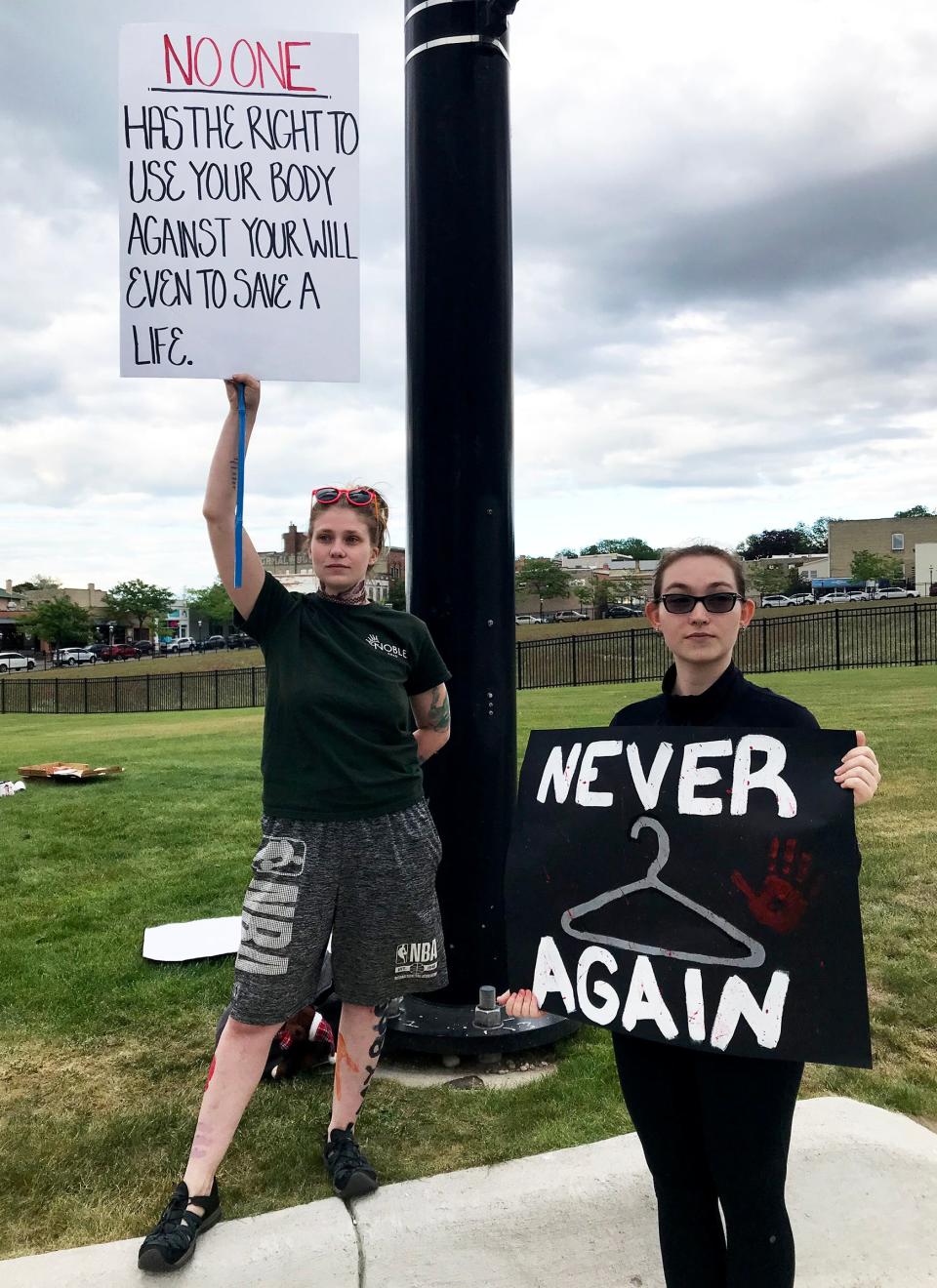 Sky VanVolkenburg (left) and Alli Stripay protest the recent Supreme Court decision overturning the 1973 Roe v. Wade case on Sunday in Petoskey.