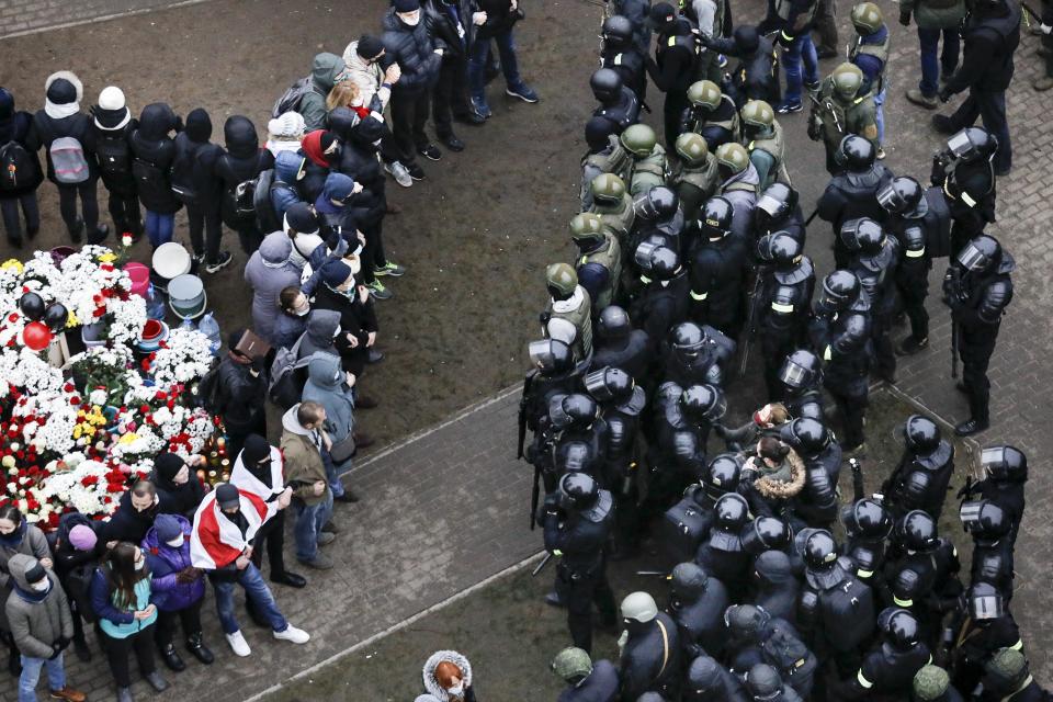 FILE - Belarusian riot police block demonstrators gather to honor 31-year-old Raman Bandarenka, who died at a Minsk hospital after several hours of surgery due to serious injuries, during an opposition rally to protest the official presidential election results in Minsk, Belarus, on Nov. 15, 2020. Authorities in Belarus have announced raids and the seizure of property of 104 opposition activists who have fled the country. The action announced on Thursday, May 16, 2024 was the latest step in the crackdown on dissent that has continued unabated for nearly four years. (AP Photo, File)