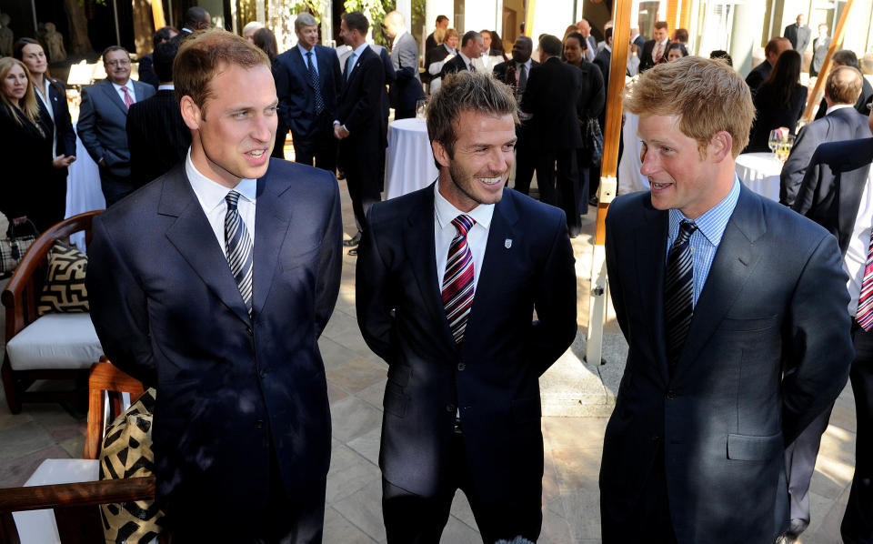 Princes William and Harry are pals with former footballer David Beckham, pictured here together in 2010 in Johannesberg, South Africa. Beckham and his wife Victoria went to both of their weddings and they have worked together on lots of sporting projects. (Photo by Luca Ghidoni - Pool/Getty Images)