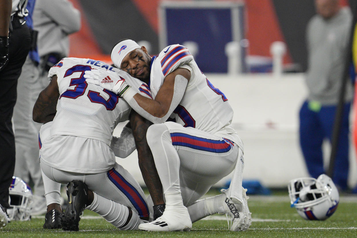 Buffalo Bills' Siran Neal (33) and Nyheim Hines react after teammate Damar Hamlin was injured during the first half of an NFL football game against the Cincinnati Bengals, Monday, Jan. 2, 2023, in Cincinnati. (AP Photo/Jeff Dean)