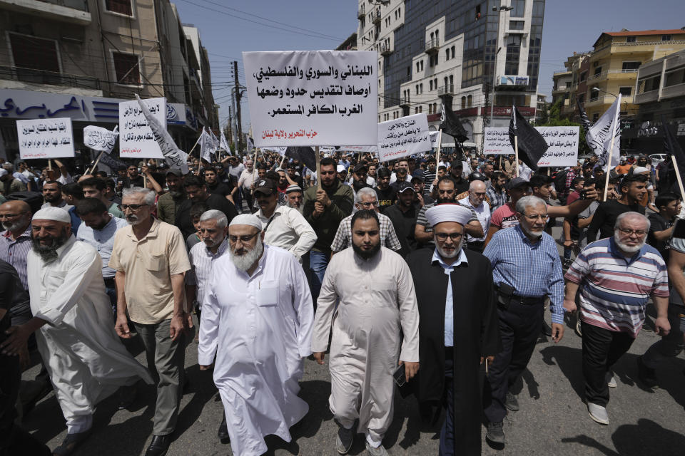 FILE - Protesters march during a protest called by the Islamic Liberation Party in support of Syrian refugees staying in Lebanon amid rising sentiments against them in the crisis-hit Mediterranean nation, in the northern city of Tripoli, Lebanon, Friday, May 17, 2024. For more than a decade, a steady flow of Syrians have crossed the border from their war-torn country into Lebanon. But anti-refugee sentiment is rising there, and over the past two months, hundreds of Syrian refugees have gone the other way. (AP Photo/Hassan Ammar, File)