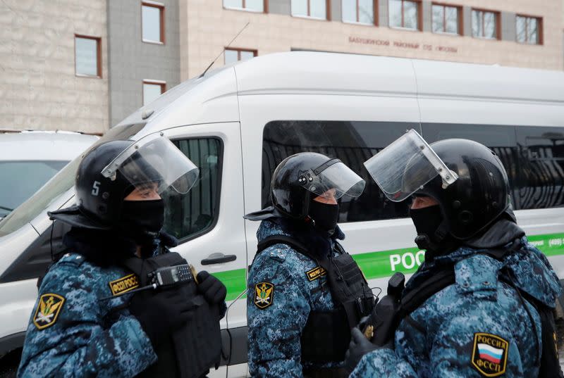 Law enforcement officers stand guard outside a court building in Moscow