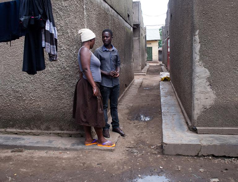 A sex worker conversing with a man at Kasensero in the rural Rakai district, on the shores of the Lake Victoria in Uganda February 21, 2014