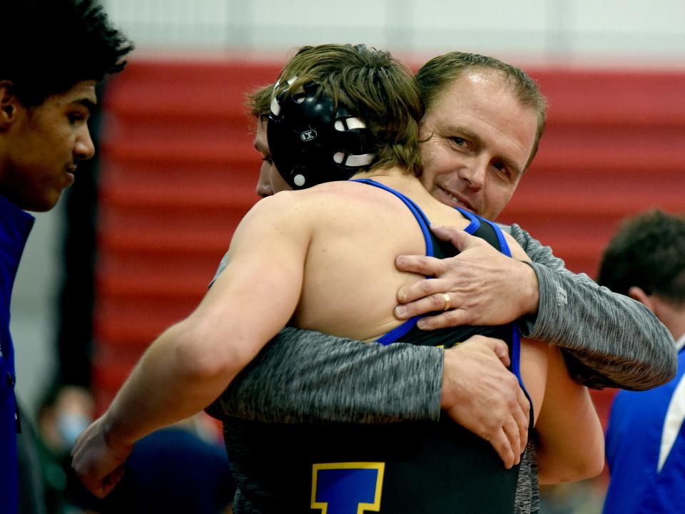 Jefferson head coach Mike Humphrey hugs Seth Minney after he beat Evan Kemp of Airport in the 160 pound match for the Huron League Championship at Milan Saturday, February 5, 2022. Minney was beaten twice by Kemp during the regular season.