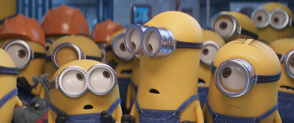 This image released by Universal Pictures shows characters, foreground from left, Bob, Kevin and Stuart in a scene from "Minions: The Rise of Gru." (Illumination Entertainment/Universal Pictures via AP)