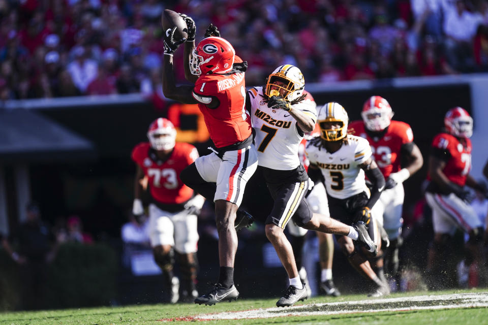 Georgia wide receiver Marcus Rosemy-Jacksaint (1) makes a catch as Missouri defensive back Kris Abrams-Draine (7) defends during the first half of an NCAA college football game, Saturday, Nov. 4, 2023, in Athens, Ga. (AP Photo/John Bazemore)