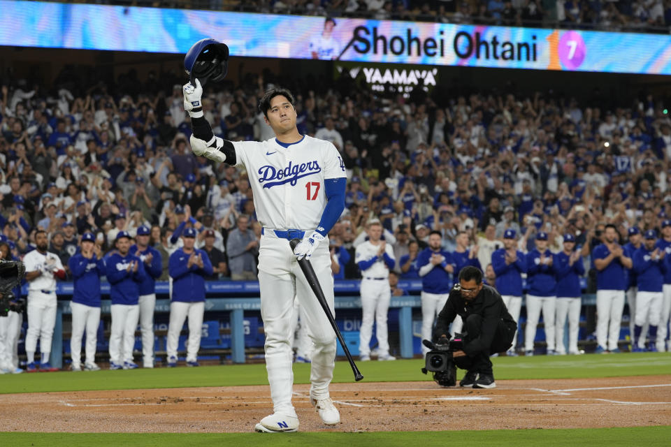 Los Angeles Dodgers designated hitter Shohei Ohtani (17) is honored during the first inning of a baseball game against the Colorado Rockies in Los Angeles, Friday, Sept. 20, 2024. Ohtani was the first MLB player to hit 50 home runs and 50 stolen bases in a single season. (AP Photo/Ashley Landis)