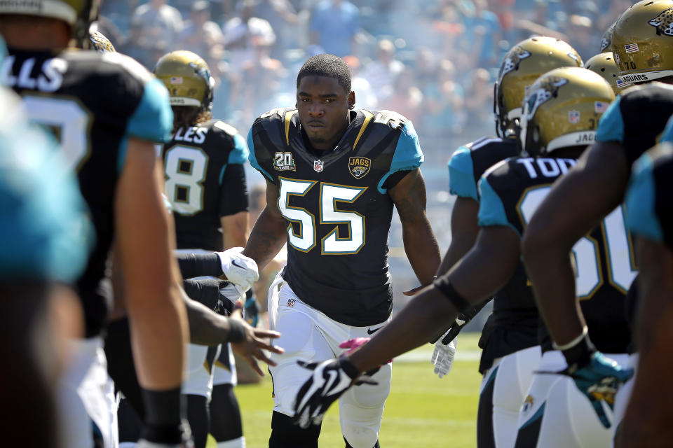 FILE - Jacksonville Jaguars outside linebacker Geno Hayes (55) runs onto EverBank Field before the start of an NFL football game against the Cleveland Browns in Jacksonville, Fla., in this Sunday, Oct. 19, 2014, file photo. Hayes, a former NFL linebacker who starred at Florida State, has died. He was 33. The Tampa Bay Buccaneers on Tuesday, April 27, 2021, confirmed his death. He had liver disease and had been in hospice care. (AP Photo/Stephen B. Morton, File)