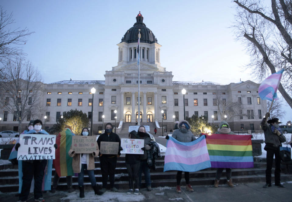 A group of LGBTQ advocates gathered outside the South Dakota Capitol in Pierre on Tuesday, Jan. 26, 2021, to protest a bill that would have banned people from updating the sex on their birth certificates. (AP Photo/Stephen Groves)