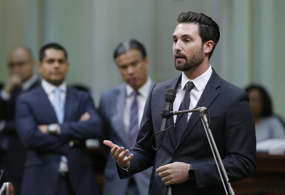 Assemblyman Ian Calderon, D-Whittier, urges lawmakers to approve a measure to give new wage and benefit protections at the so-called gig economy companies like Uber and Lyft, during the Assembly session in Sacramento, Calif., Wednesday, Sept. 11, 2019. The bill AB5, by Assemblywoman Lorenza Gonzalez, D-San Diego, was approved and now goes to the governor, who has said he supports it. (AP Photo/Rich Pedroncelli)