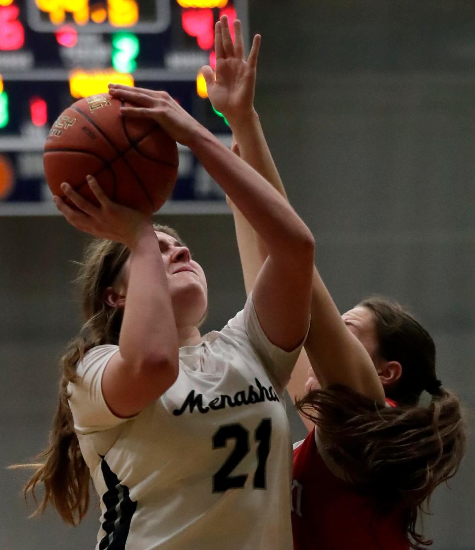 Menasha's Hannah Neubert (21) puts up a shot against Pulaski during their girls basketball game Dec. 28 in Menasha.
