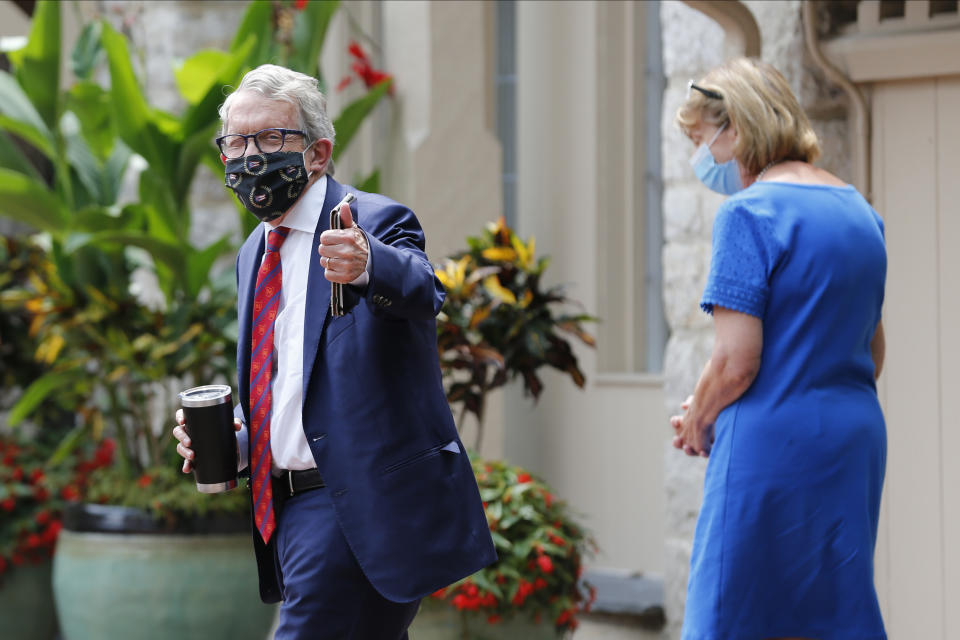 Ohio Governor Mike DeWine, left, and his wife Fran, walk into their residence after he tested positive for COVID-19 earlier in the day Thursday, Aug. 6, 2020, in Bexley, Ohio. (AP Photo/Jay LaPrete)