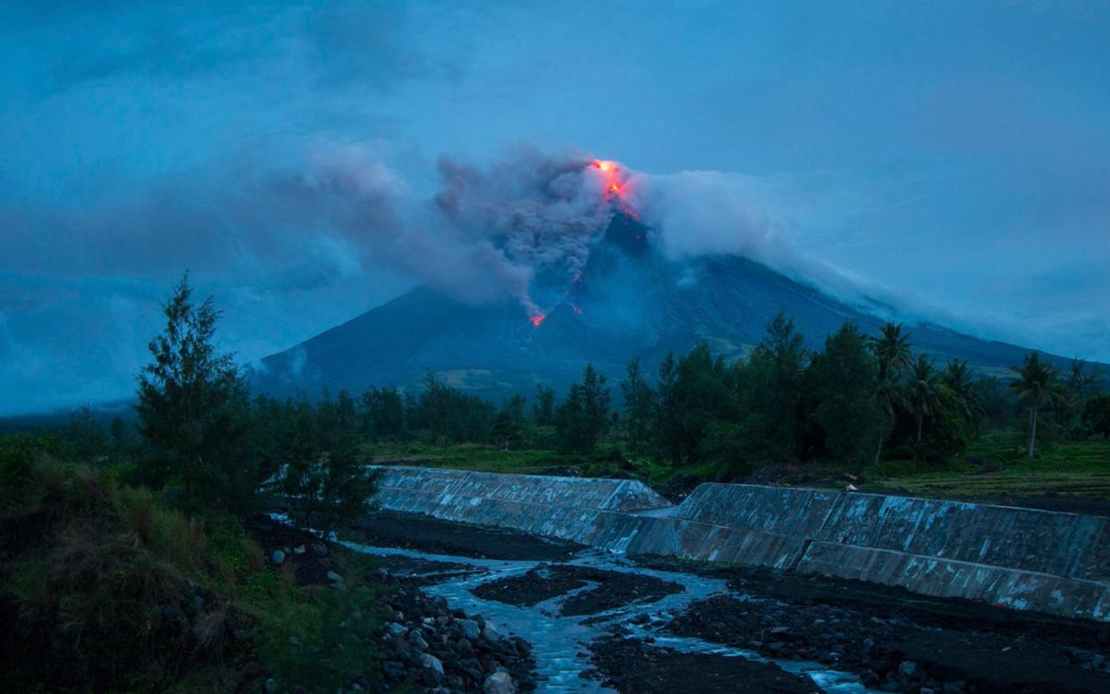 The Mayon volcano lies 210 miles southeast of Manila - STR