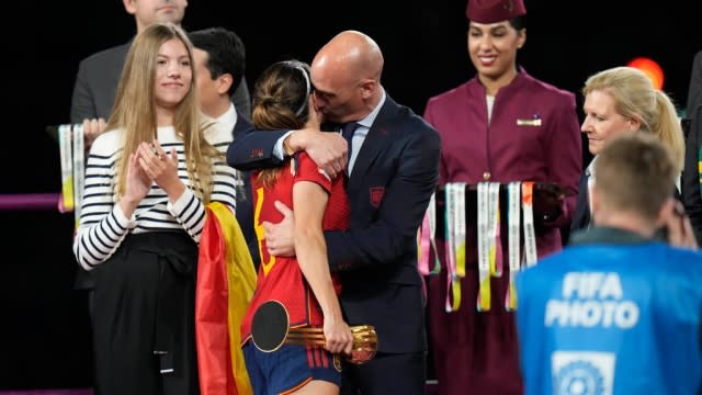 President of Spain's soccer federation, Luis Rubiales, hugs and kisses Spain's Aitana Bonmati.