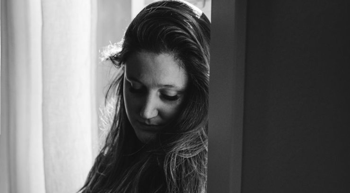 Tori Roloff poses in a black and white photograph showcasing her growing baby bump.