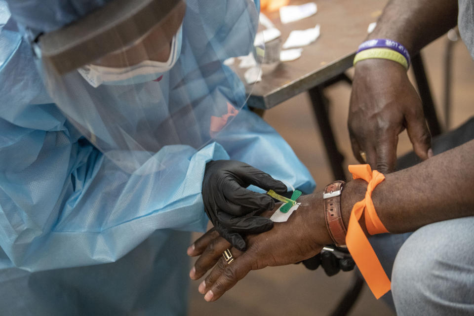 A registered nurse draws blood during a COVID-19 antibody test drive at the Abyssinian Baptist Church, Thursday, May 14, 2020, in the Harlem neighborhood of the Manhattan. Churches in low income communities across New York are offering COVID-19 testing to residents in conjunction with Northwell Health and New York State. (AP Photo/Mary Altaffer)