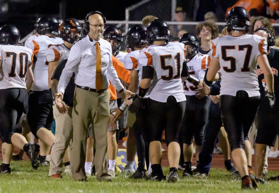 Elmwood/Brimfield head coach Todd Hollis congratulates his team after a touchdown against Farmington in the second half of their varsity football game Friday, Sept. 22, 2023 in Farmington. The Farmers defeated the Trojans 30-26.