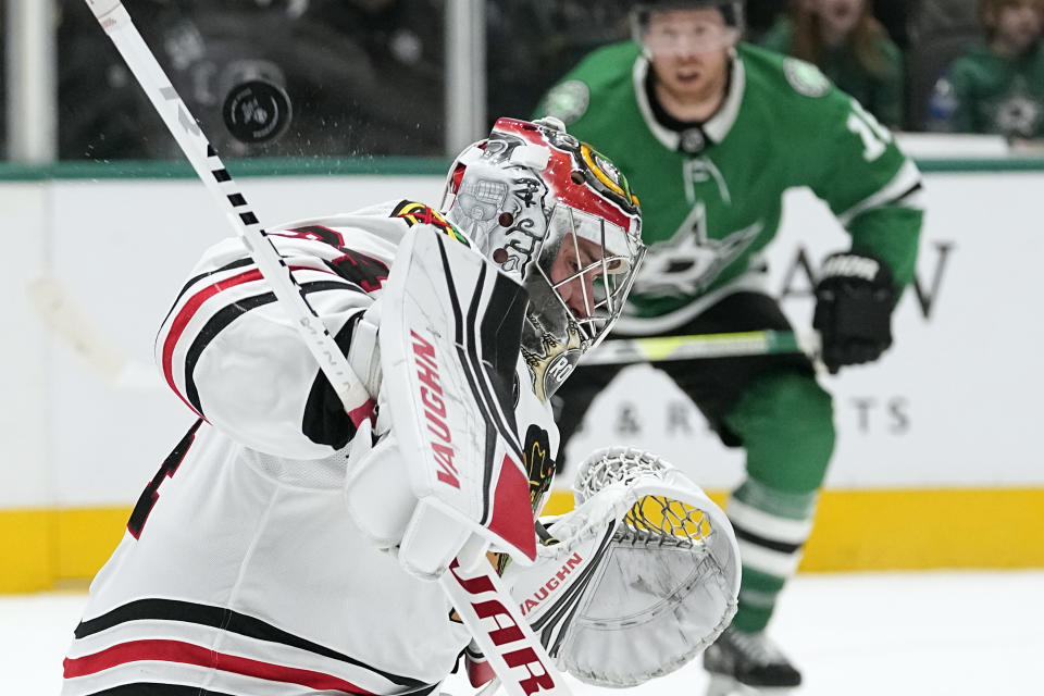 Chicago Blackhawks goaltender Petr Mrazek (34) deflects a shot as Dallas Stars center Sam Steel (18) looks on during the first period of an NHL hockey game in Dallas, Friday, Dec. 29, 2023. (AP Photo/LM Otero)