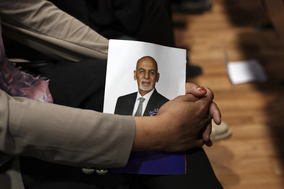 A supporter holds a portrait of Afghan presidential candidate Ashraf Ghani during the first day of campaigning in Kabul, Afghanistan, Sunday, July 28, 2019. Sunday marked the first day of campaigning for presidential elections scheduled for Sept. 28. President Ghani is seeking a second term on promises of ending the 18-year war but has been largely sidelined over the past year as the U.S. has negotiated directly with the Taliban. (AP Photo/Rahmat Gul)