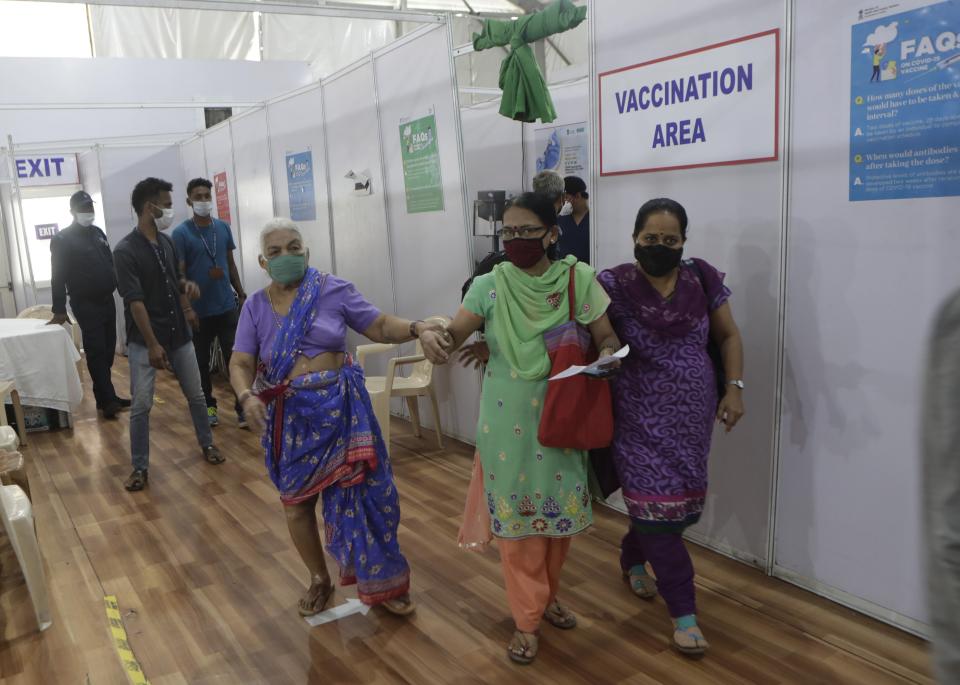 A woman leaves after receiving her second dose of the COVID-19 vaccine at a vaccination center that is closed for fresh registrations for first doses because of shortage the vaccine, in Mumbai, India, Friday, April 9, 2021. India has a seven-day rolling average of more than 100,000 cases per day and has reported 13 million virus cases since the pandemic began, the third-highest total after the United States and Brazil. (AP Photo/Rajanish Kakade)