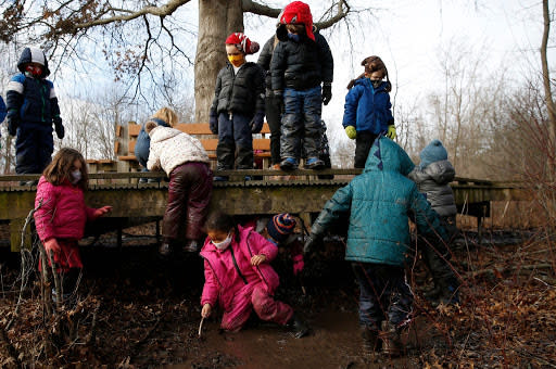 Jan. 6: Members of the Magnificent Monarchs, a class for young children at Boston, Massachusetts, Nature Center play in the mud and along the boardwalk during their school day. (Getty Images)