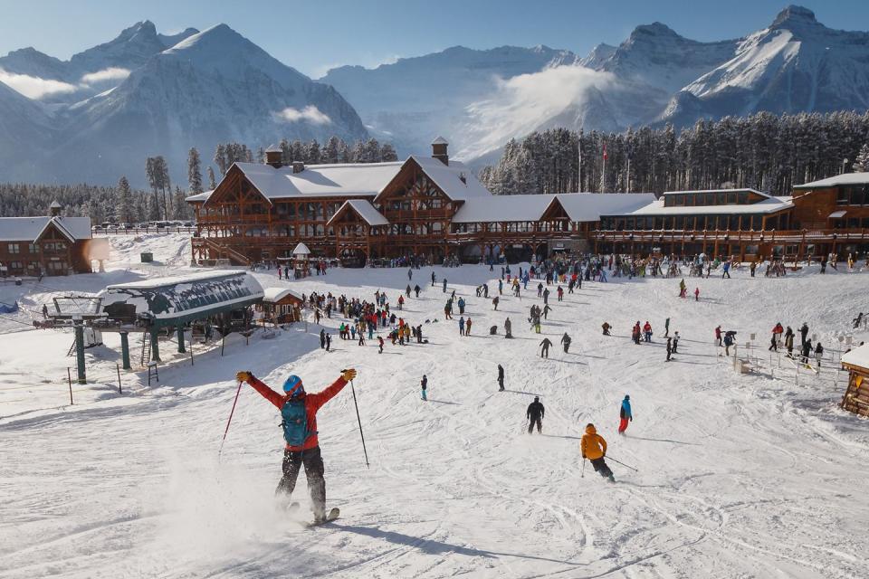 a group of people skiing on the snow at lake louise