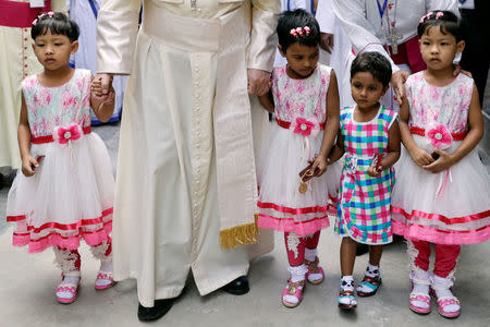 Pope Francis is accompanied by children as he leaves at the end of his visit to Mother Teresa House in the Dhaka's Tejgaon neighborhood, Bangladesh, December 2, 2017. REUTERS/Andrew Medichini/Pool