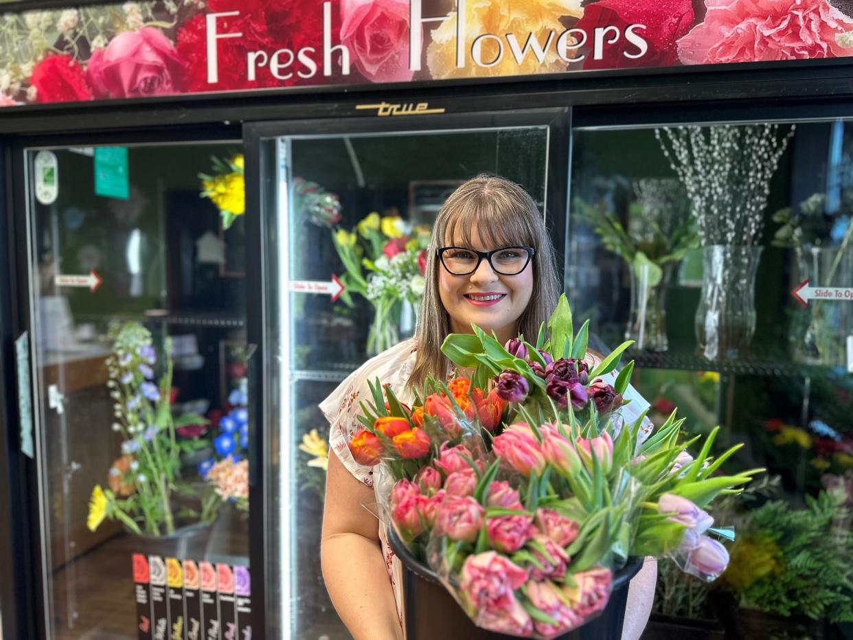 Stephanie Schoel shows off flowers that are for sale at Secret Garden Floral Design, 1042 Main St. in Oconto. Schoel opened the business in December.