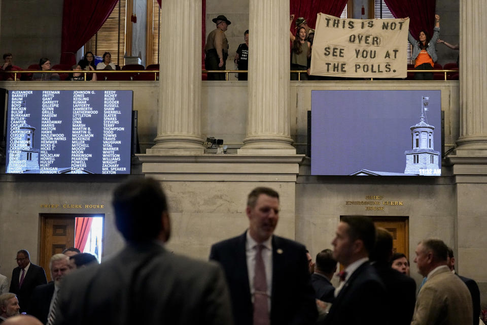 Protesters display a banner over the House chamber floor during a legislative session Thursday, April 25, 2024, in Nashville, Tenn. (AP Photo/George Walker IV)