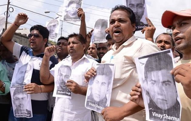 Indian activists of the Bhartiya Janta Party Scheduled Caste Morcha, shout slogans as they hold posters of four accused in a gang rape case of a student in New Delhi during a demonstration in Amritsar on September 11, 2013