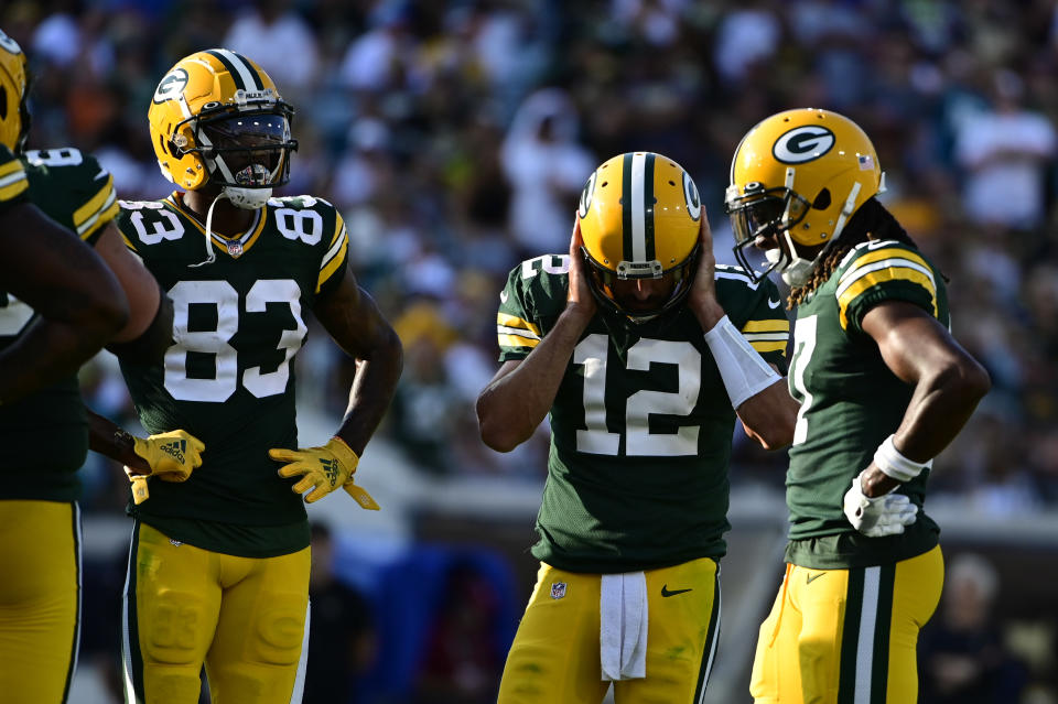 Sep 12, 2021; Jacksonville, Florida, USA;  Green Bay Packers quarterback Aaron Rodgers (12) covers his ears in the huddle during the third quarter against the New Orleans Saints at TIAA Bank Field. Mandatory Credit: Tommy Gilligan-USA TODAY Sports