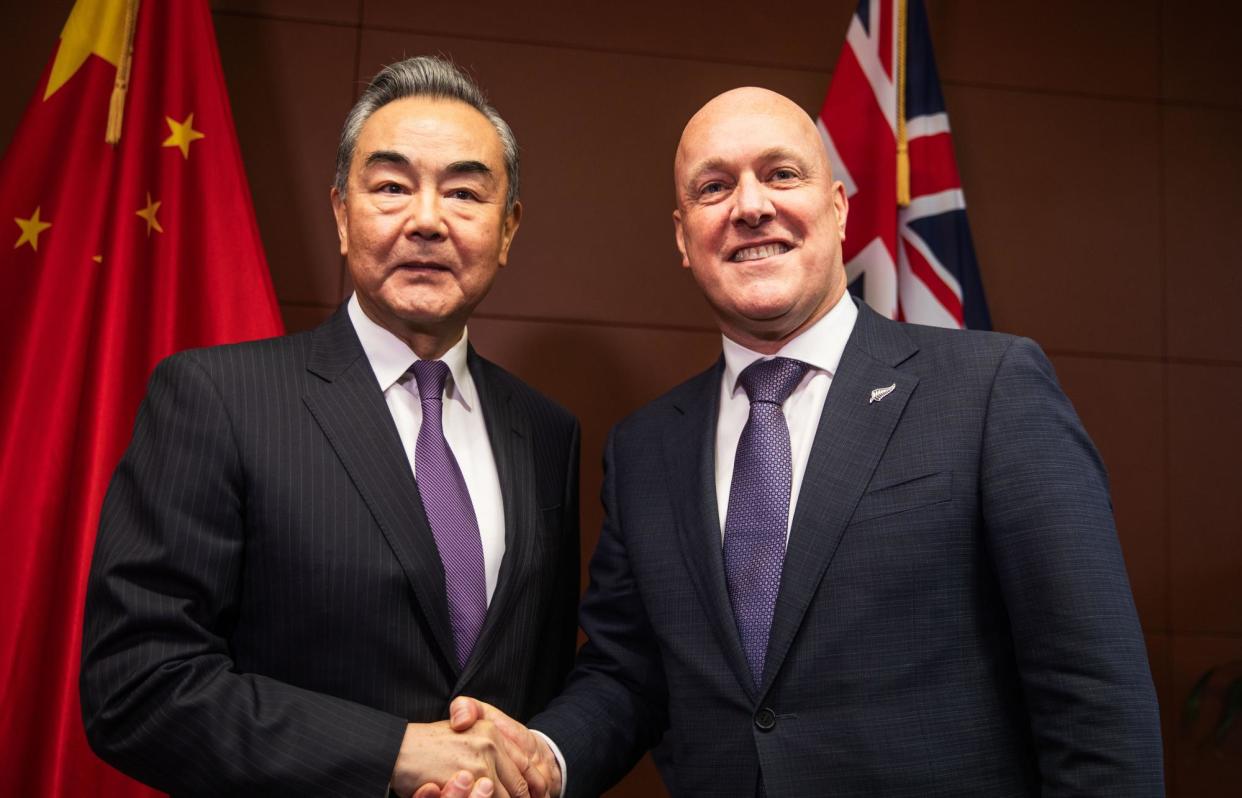 <span>Chinese foreign minister Wang Yi greets New Zealand prime minister Christopher Luxon in Wellington on 18 March 18. New Zealand has opted against applying sanctions over China’s alleged hacking operations.</span><span>Photograph: Getty Images</span>