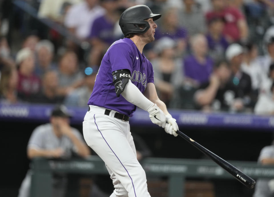 Colorado Rockies' Ryan McMahon follows the flight of his three-run home run off Chicago White Sox starting pitcher Michael Kopech in the fourth inning of a baseball game Friday, Aug. 18, 2023, in Denver. (AP Photo/David Zalubowski)