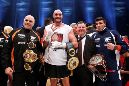 Tyson Fury celebrates winning the fight with trainer and father Peter Fury (L) Action Images via Reuters / Lee Smith Livepic