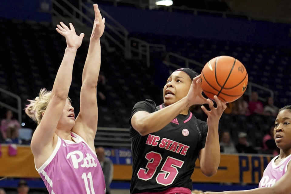 North Carolina State guard Zoe Brooks (35) drives around Pittsburgh guard Marley Washenitz (11) during the first half of an NCAA college basketball game Sunday, Feb. 11, 2024, in Pittsburgh. (AP Photo/Matt Freed)