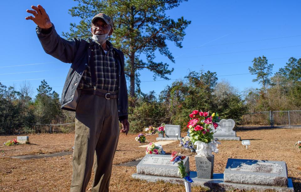 George Macdonald "Mac" Arrington, points out grave plots belonging to his ancestors at Altair Missionary Baptist Church in Waynesboro, Miss., Wednesday, Jan. 26, 2022.