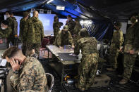 Japan's Self-Defense Force soldiers and U.S. Marines soldiers, left, take part in a joint military drill between Japan Self-Defense Force, French army and U.S. Marines, at the Kirishima exercise area in Ebino, Miyazaki prefecture, southern Japan Saturday, May 15, 2021. (Charly Triballeau/Pool Photo via AP)