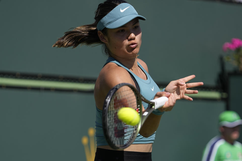 Emma Raducanu, of Britain, returns to Beatriz Haddad Maia, of Brazil, at the BNP Paribas Open tennis tournament Monday, March 13, 2023, in Indian Wells, Calif. (AP Photo/Mark J. Terrill)