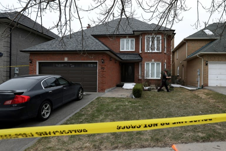 A police officer walks around the house of the van massacre suspect Alek Minassian in the Toronto suburb of Richmond Hill