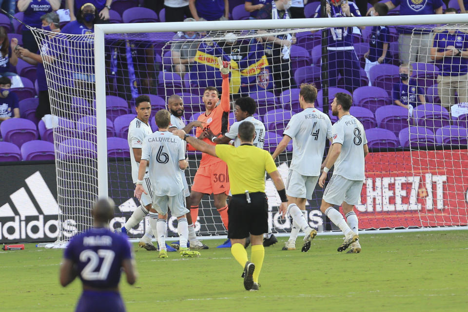 New England Revolution goalkeeper Matt Turner (30) celebrates with teammates after making a save on a penalty kick by Orlando City forward Nani (not shown) during the second half of an MLS playoff soccer match, Sunday, Nov. 29, 2020, in Orlando, Fla. (AP Photo/Matt Stamey)